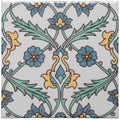 A square ceramic tile featuring an intricate floral pattern in blue teal and yellow on a light gray background from topkapi yellow on helmingham