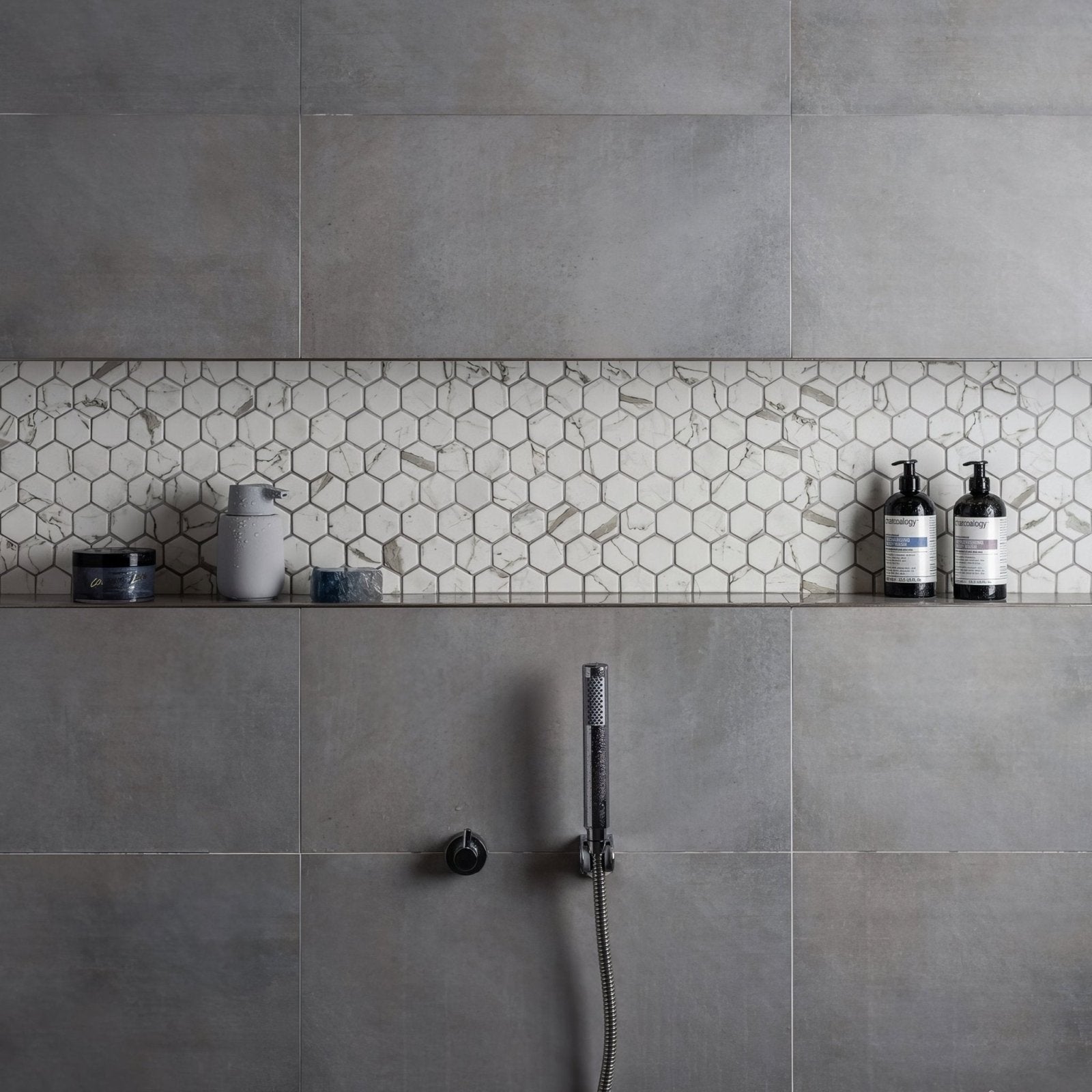 Torcello White Hexagon white hexagonal mosaic accent strip on a grey concrete wall