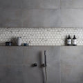 Torcello White Hexagon white hexagonal mosaic accent strip on a grey concrete wall