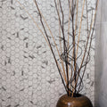 Torcello White Hexagon white hexagonal mosaic with a woven bamboo vase of dried branches