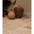 Two woven wicker vases in natural brown tones featuring a round shape and a taller lid design from touraine limestone seasoned