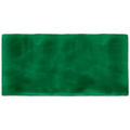 A rectangular deep green velvet tourmaline brick tile mat with soft plush texture and slightly uneven edges