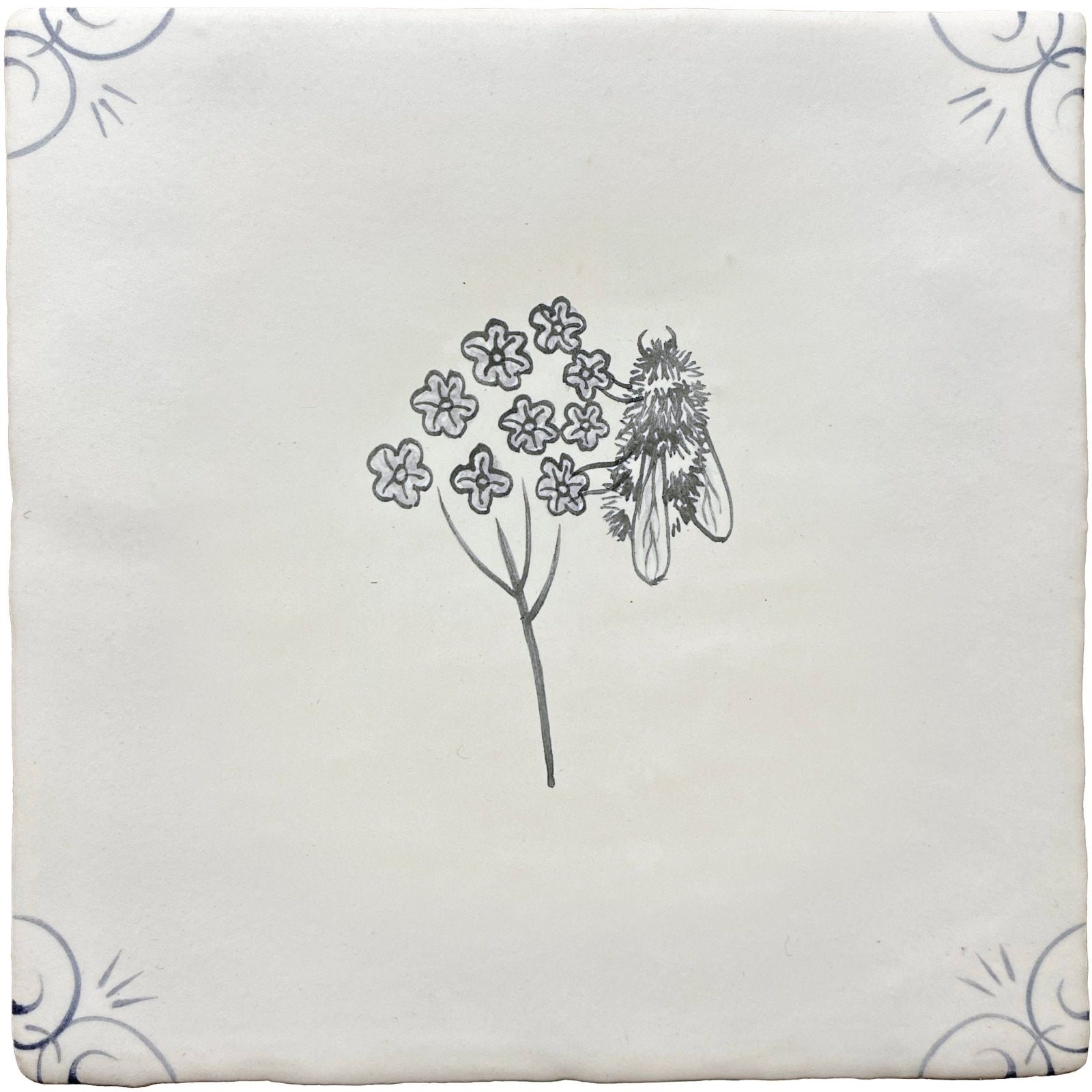 A square off-white ceramic tile with a delicate black ink illustration of flowers and a fly in traditional english delft bee style