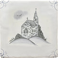 White ceramic tile with hand-painted black and gray traditional english delft church illustration on a hill
