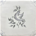 A square white ceramic tile with a hand-painted black and gray traditional English Delft dove on a branch