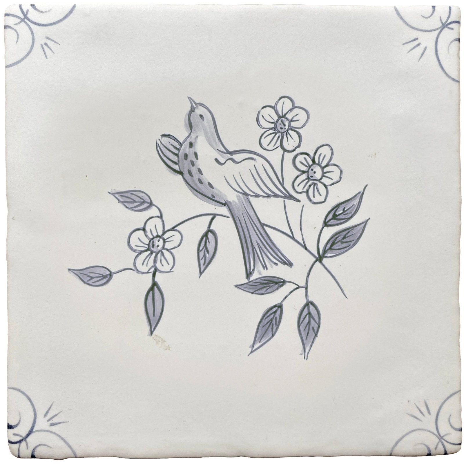 Traditional English Delft swift ceramic tile with hand-painted gray bird on floral branch on off-white background