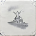 A white ceramic tile with a hand-painted black and gray traditional english delft windmill and ornate corners