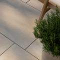 Beige rectangular trafalgar sandstone etched paving tiles with subtle texture and dark grout lines for patios