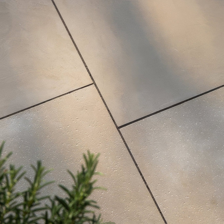 Beige trafalgar sandstone etched paving tiles with textured stone finish and dark grout lines for outdoor use