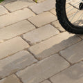 Beige rectangular tumbled sandstone pavers arranged in a staggered pattern from trafalgar sandstone tumbled cobbles