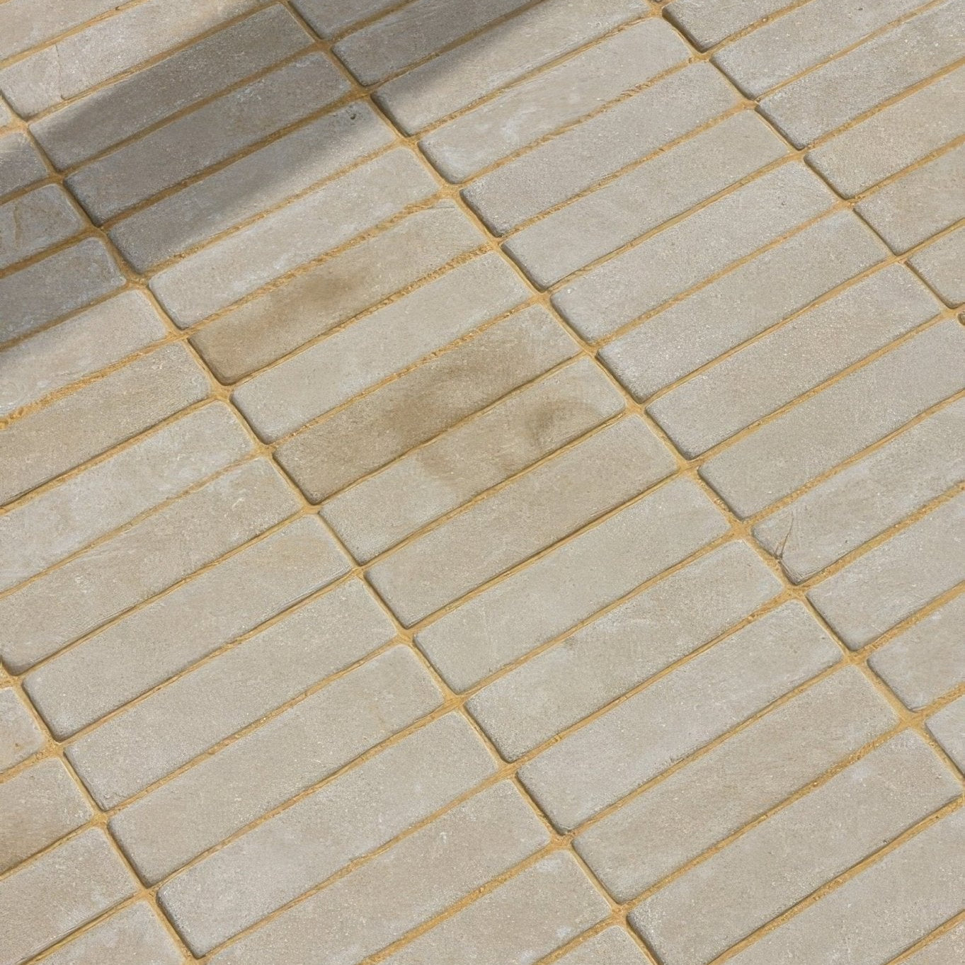 Beige rectangular sandstone tumbled klinkers with golden grout lines for decorative flooring and walls
