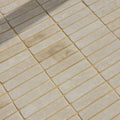 Beige rectangular sandstone tumbled klinkers with golden grout lines for decorative flooring and walls