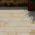 Beige rectangular Trafalgar sandstone tumbled klinkers tiles arranged in a grid pattern with light-colored grout