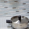 Trip Lluvia Blanco Mosaic light blue and white glass mosaic with a stainless steel saucepan