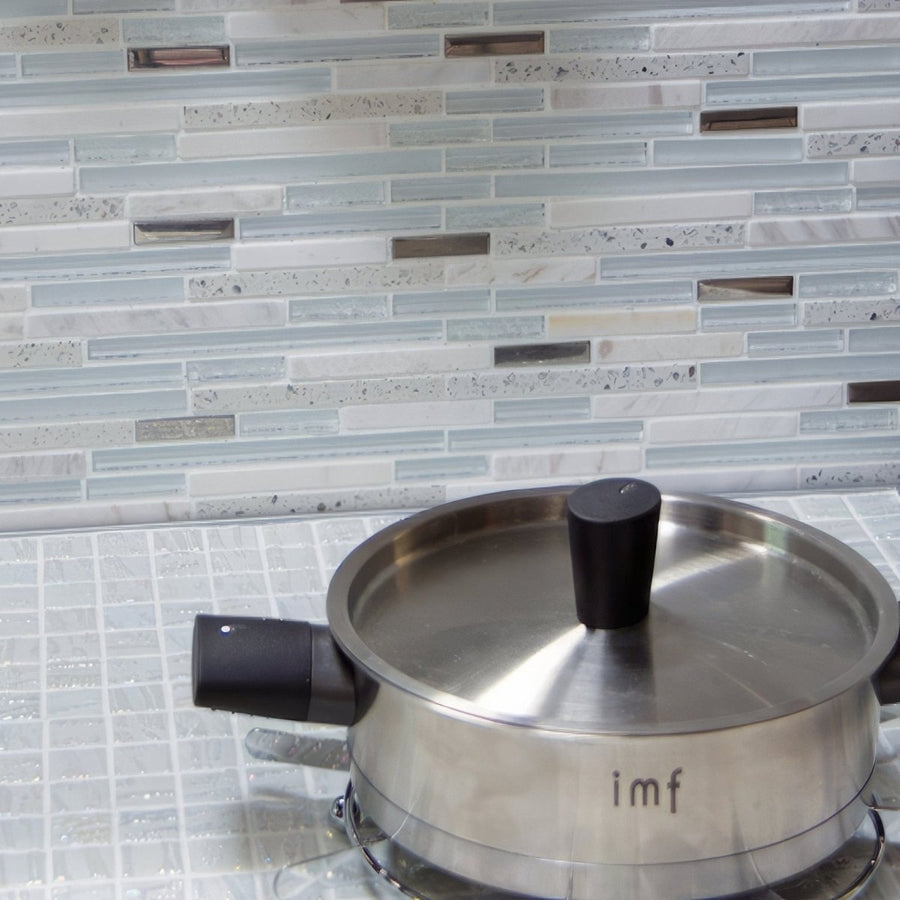 Trip Lluvia Blanco Mosaic light blue and white glass mosaic with a stainless steel saucepan