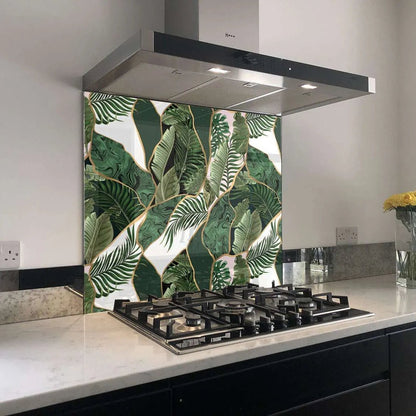 Tropical abstract wall panel glass kitchen backsplash with green and white leaf pattern and gold outlines