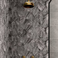 Gold-toned classic rounded showerhead mounted above gray tropical leaf patterned tile from tropical oasis monochrome single tile