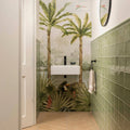 White ceramic wall-mounted sink with sleek black faucet featured in tropical oasis decorative 8-tile set panel a