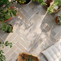 Light gray trusloe limestone seasoned finish parquet tiles arranged in a herringbone pattern