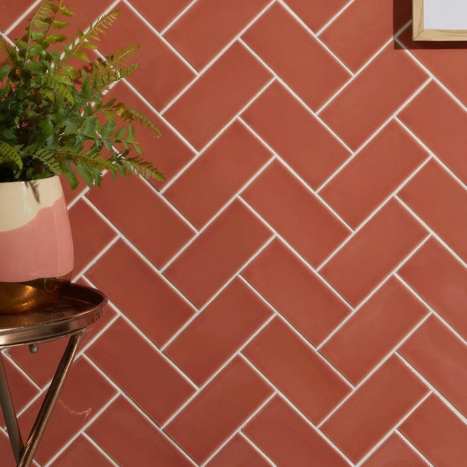 Tunstall ceramic brick coral terracotta ceramic wall tiles with white grout in a herringbone pattern