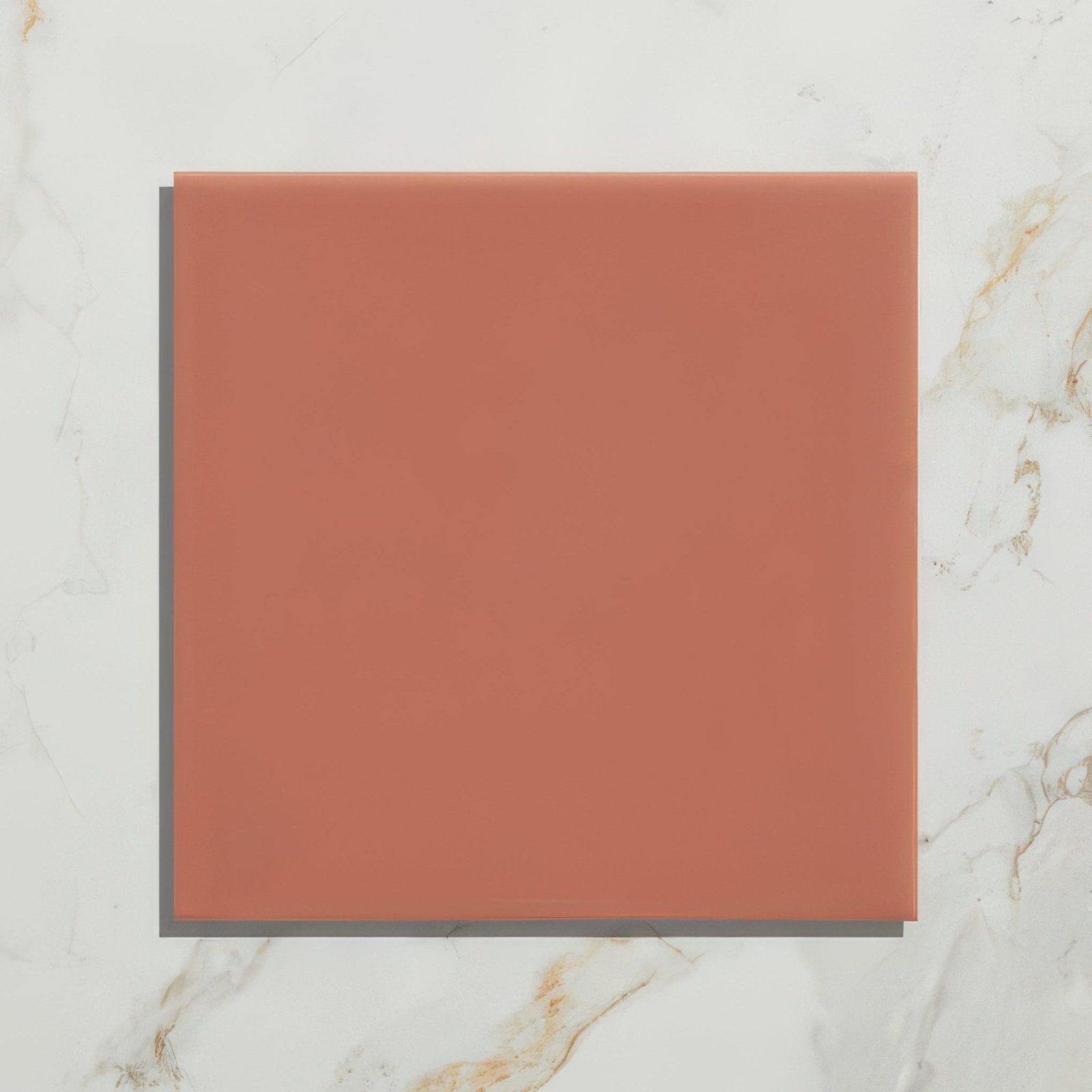 A square terracotta-colored ceramic tile with a smooth matte finish from the tunstall ceramic coral square collection