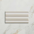 Cream-colored rectangular ceramic tile with a classic ribbed design from tunstall ceramic fluted brick deep white collection