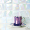 Ultimo Shell Iridescent Mosaic iridescent glass mosaic with a purple espresso cup and saucer