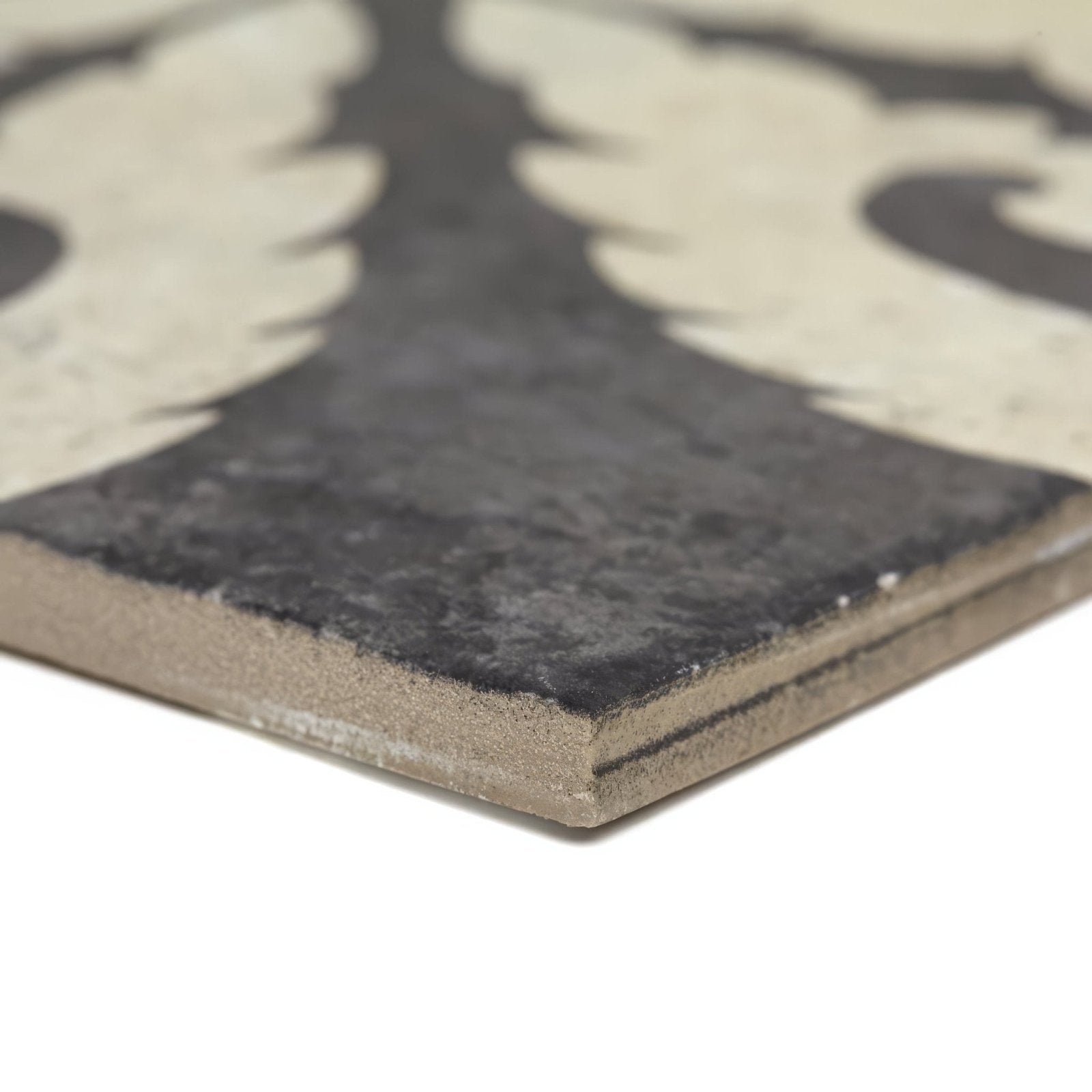 Dark gray urban velasco patterned porcelain tile with textured matte finish and off-white ornate leaf design