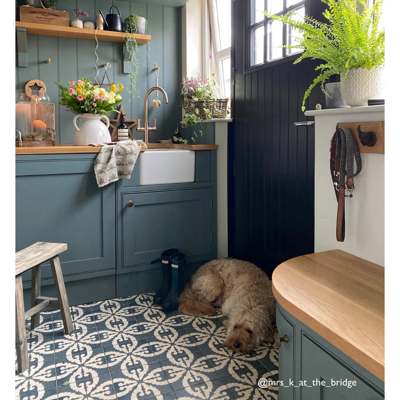 A fluffy light brown dog resting on urban velasco patterned light beige porcelain tile floor