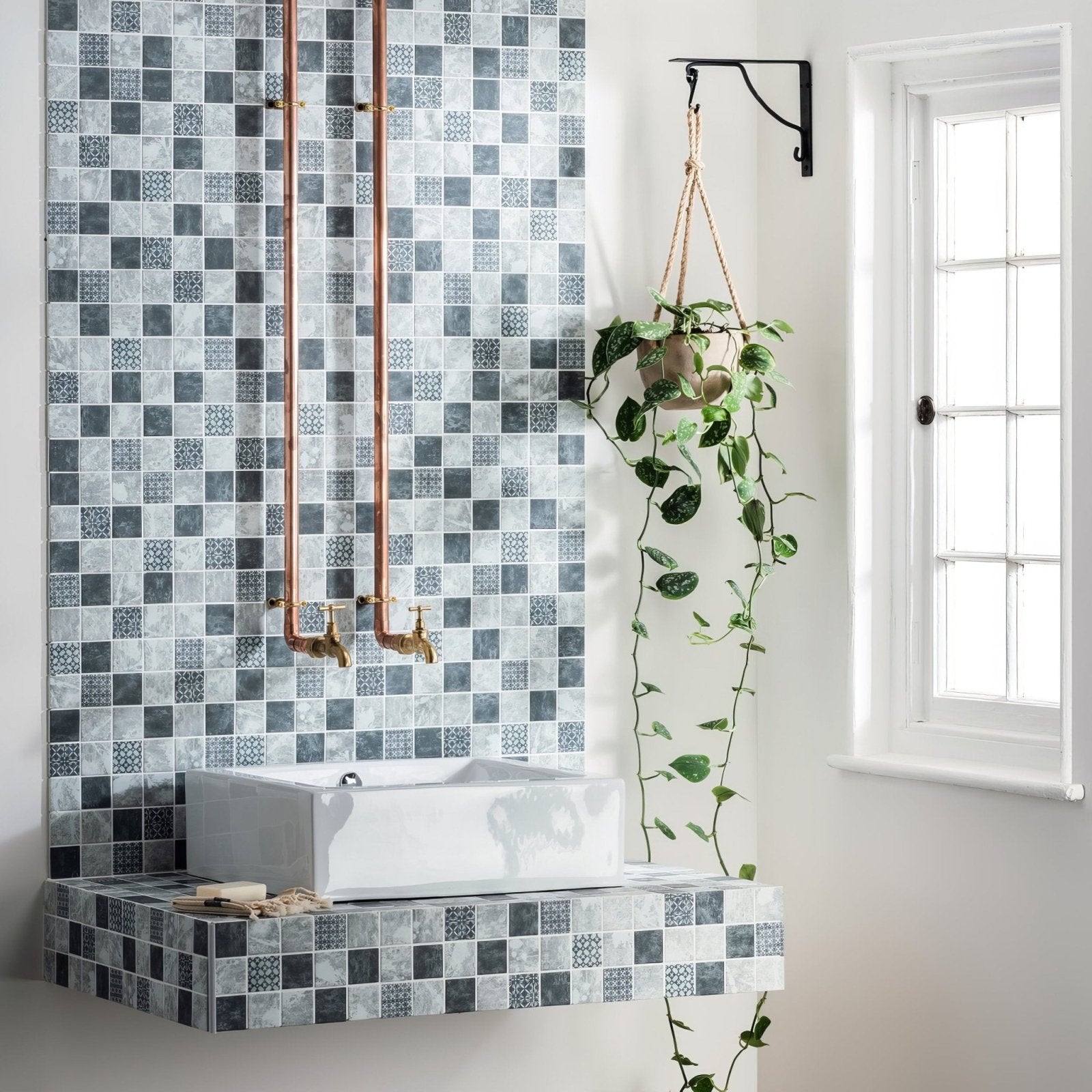 Venetia Glass Mosaic grey and black glass mosaic with a white vessel sink on a floating countertop