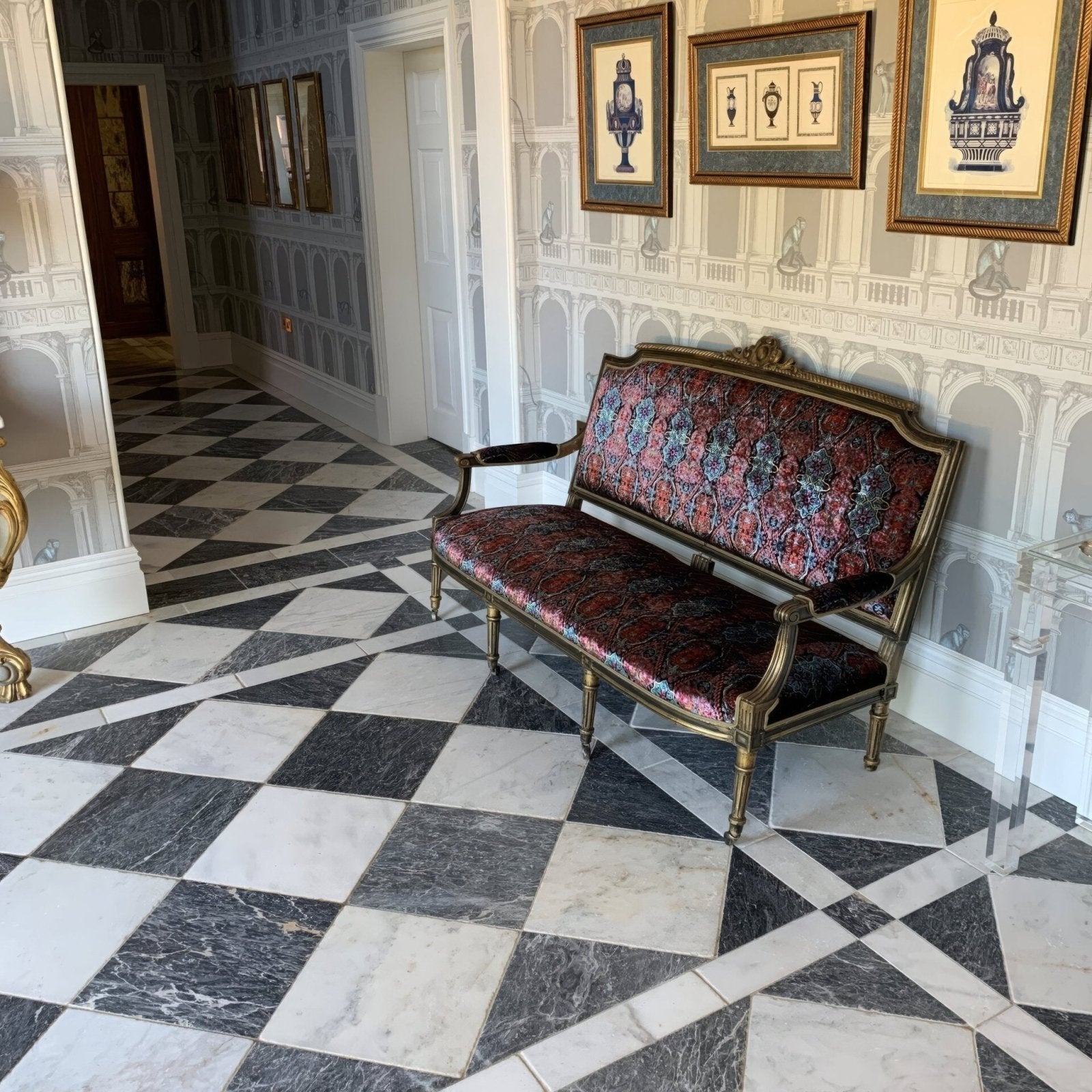 Venetian black and white marble checkerboard tiles with an antique bench