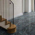 Dark gray marble flooring with swirling white veining in versailles marble vert honed finish