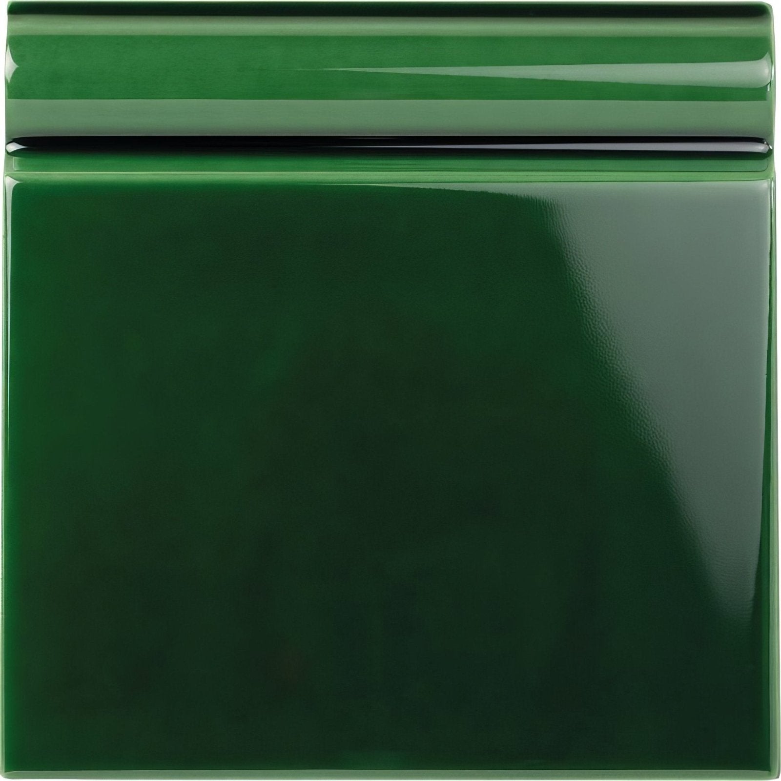 Victorian green skirting tile made of glossy emerald green ceramic with a smooth reflective surface and subtle raised border