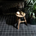 Victorian Style Porcelain Anthracite Field black porcelain field tiles with a rustic wooden stool