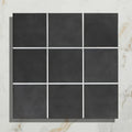 Nine square victorian style porcelain anthracite field tiles in black matte with white grout lines arranged in a grid