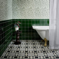 Victorian Style Porcelain Finchley Pattern Soft Grey grey geometric tiles with a white clawfoot bathtub
