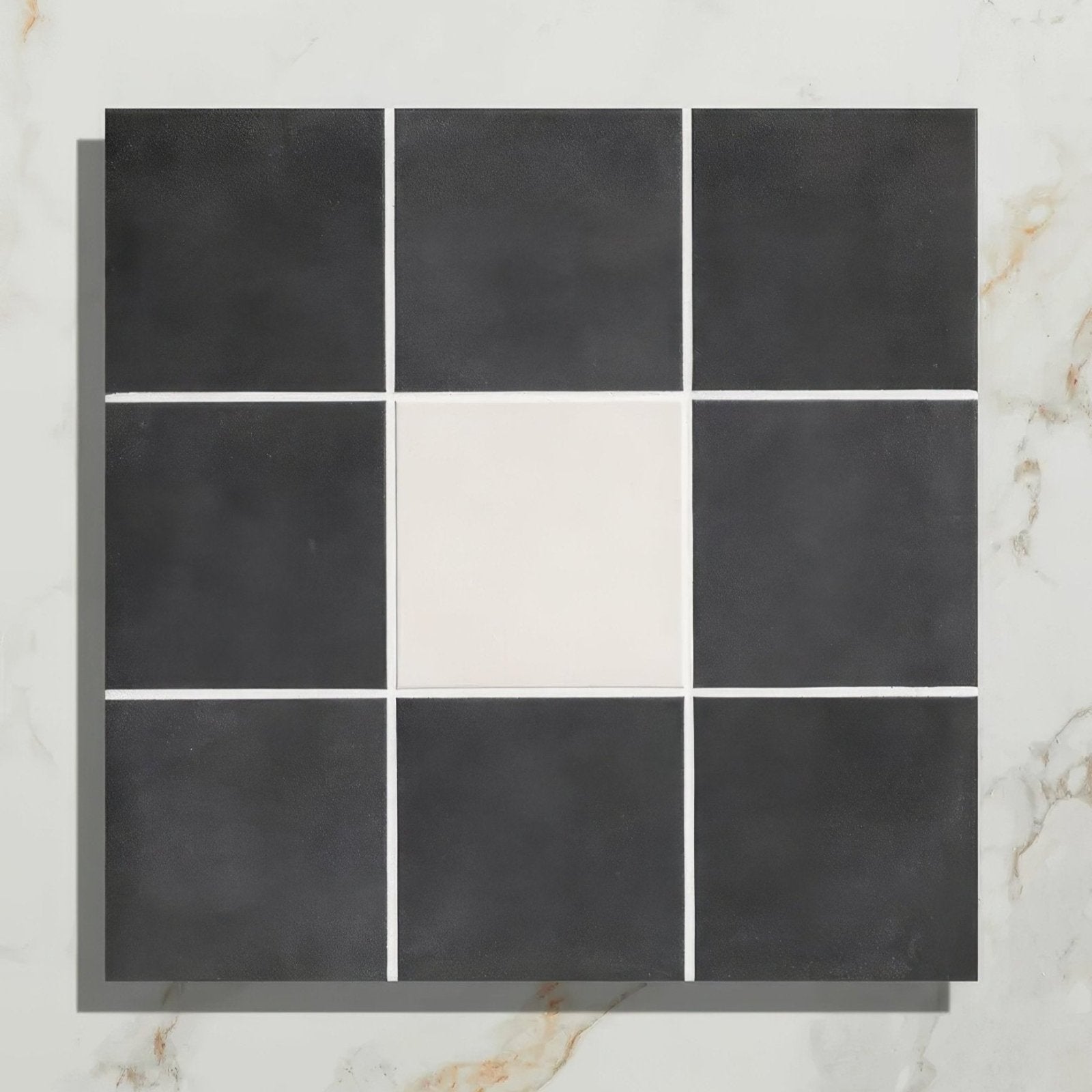 Victorian style porcelain frame with black and white square mosaic tiles and a central cream-colored tile