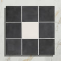 Victorian style porcelain frame with black and white square mosaic tiles and a central cream-colored tile