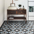 Victorian Style Porcelain Frame black, white and beige frame border tiles with a dark wood vanity and concrete sink