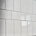 White glossy Victorian Style wall ceramic tiles with antique white crackle glaze arranged in classic brick pattern