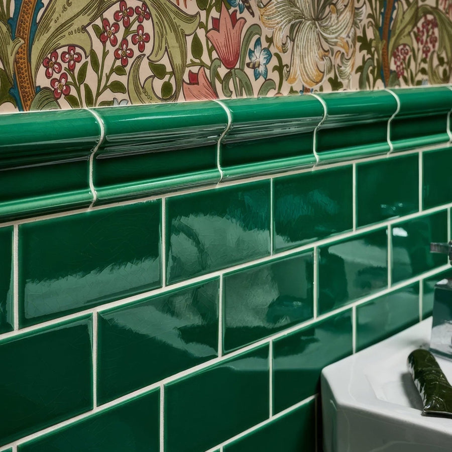 Victorian Style wall ceramic emerald green glossy subway tiles with white grout and a curved tile header detail
