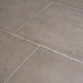 Gray vienne limestone satino stone tiles with subtle veining and white grout lines for flooring and wall use
