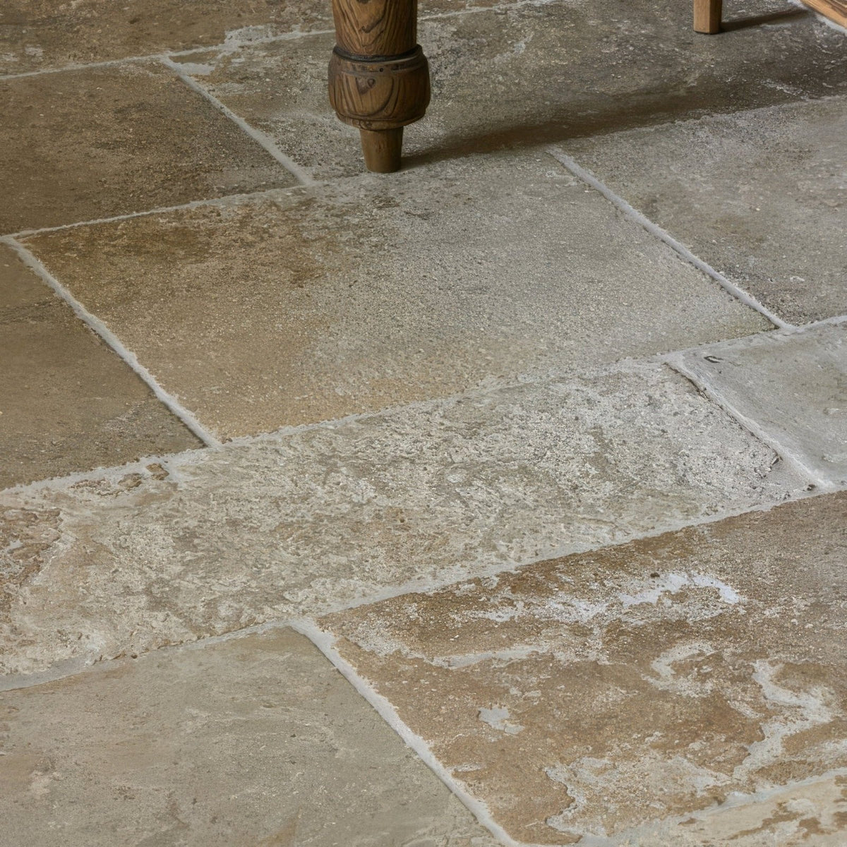 Beige and tan vieux bourgogne limestone floor tiles with a rustic textured ancient finish
