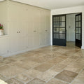Beige vieux bourgogne limestone artisan antiqued finish stone tiles with natural variations and subtle veining on floor