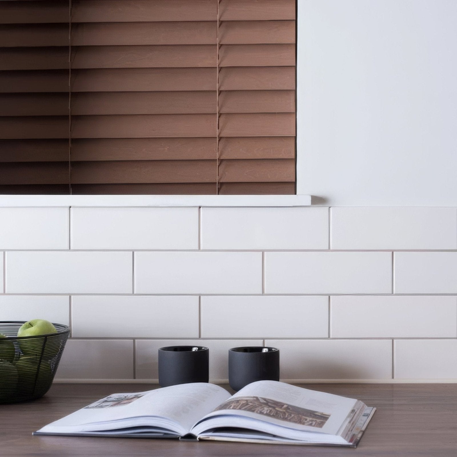 Open vintage white large brick book with white pages and black text resting on a wooden surface
