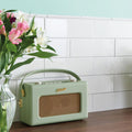 Vintage white omega moulding featuring a mint green roberts vintage-style portable radio with woven grille and gold-tone accents