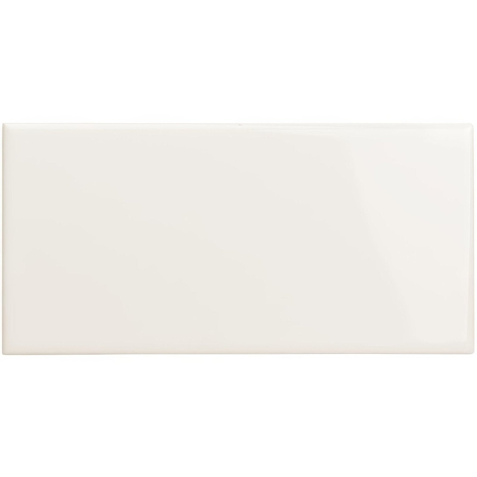Cream-colored glossy rectangular ceramic tile with rounded edges from the vintage white long collection