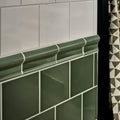 Dark green ceramic tile trim with glossy finish and curved decorative profile for victorian style wall ceramic cabbage green square