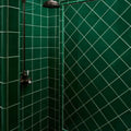 Deep emerald green victorian style wall ceramic tiles with crackle glaze and white grout in a diamond pattern
