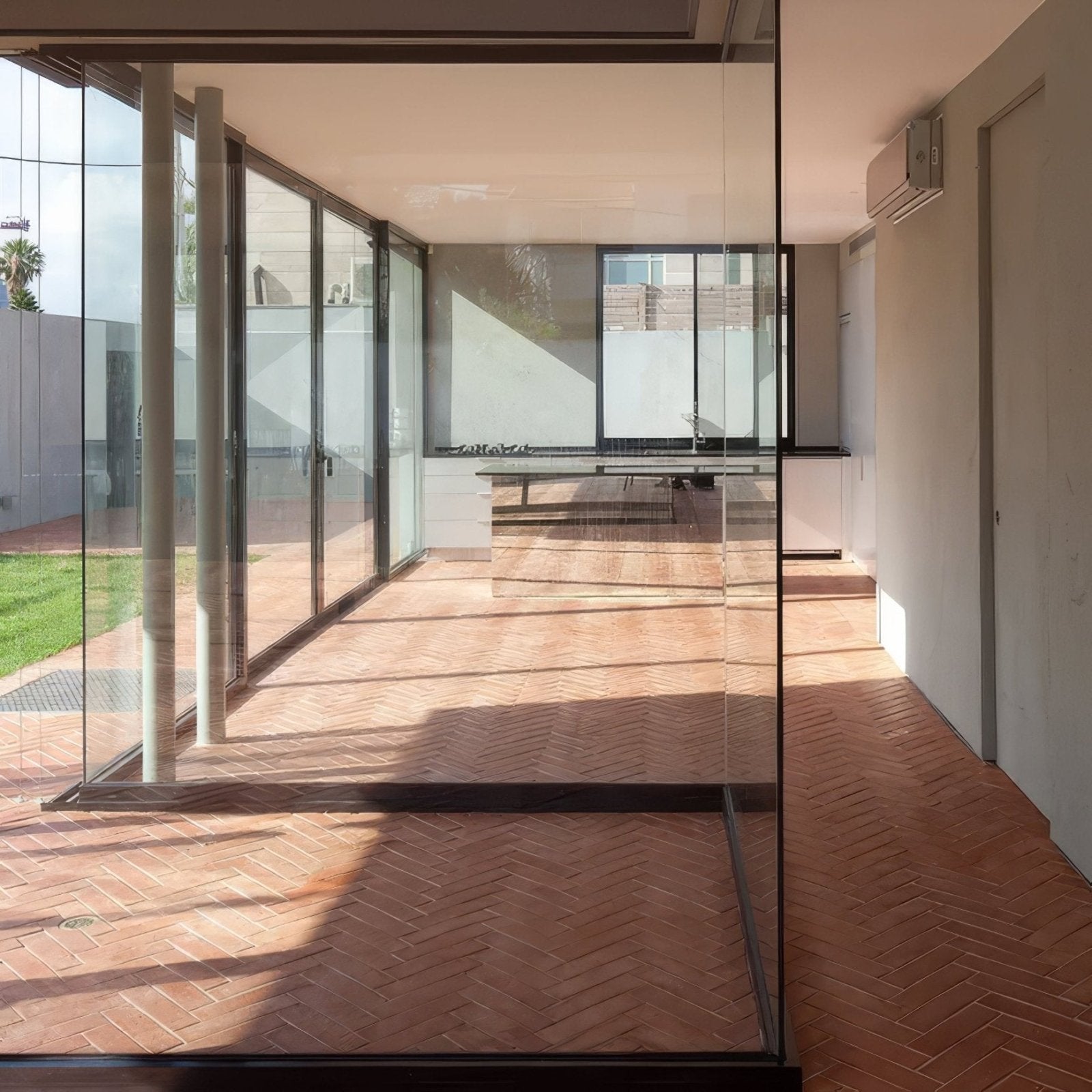 Wansdyke external terracotta flooring in terracotta color with herringbone pattern in a modern glass interior